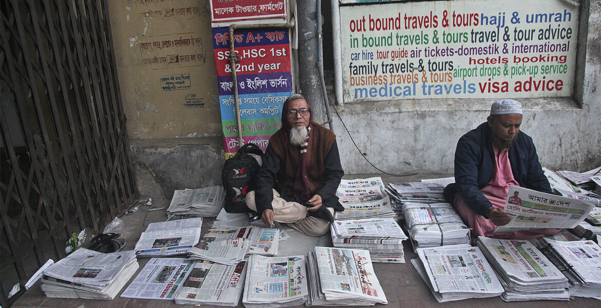Tidningsförsäljare på en gata i Dhaka.