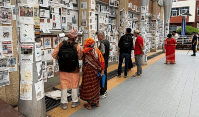 En vägg vid Teaching Hospital i Katmandu har fyllts med fotografier av människor som är anmälda försvunna efter naturkatastrofen vid gränsen till Tibet 26 augusti 2026.